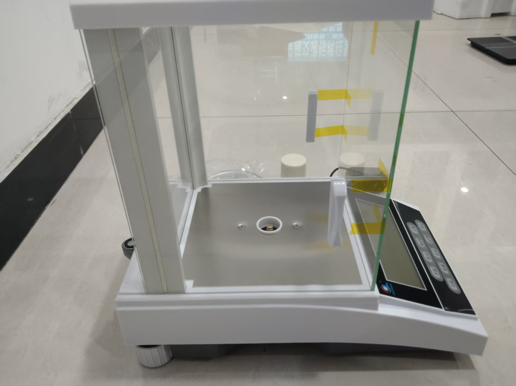 Specification	Details Model	Jewellery & R-D Precision Balance – 2 kg Maximum Capacity	2000 g (2 kg) Readability (Resolution)	0.01 g (10 mg) Repeatability	±0.02 g Linearity	±0.05 g Weighing Units	g, mg, oz, lb, ct (units vary) Display Type	Backlit LCD digital screen Weighing Pan Material	Stainless steel Pan Size	Approx. 120–150 mm diameter Calibration	Manual / automatic (model dependent) Operating Temperature	10 °C – 30 °C Power Supply	AC adapter (100–240 V) & battery (optional) Housing Material	ABS plastic or metal frame Net Weight	Approx. 2.5–4 kg Stabilization Time	≤ 2–3 seconds Data Interface	RS232/USB (optional, model dependent) ________________________________________ Functions & Capabilities •	Tare / Zero: Reset the display for net weight readings •	Unit Conversion: Quickly switch between multiple weighing units •	Stability Indicator: Confirms when the reading is stable •	Auto Power-Off: Helps conserve power •	Low Battery Indicator: Alerts when batteries need replacement •	Overload Warning: Signals if capacity is exceeded •	Optional Data Output: For PC, printer, or data logging (if supported) ________________________________________ Applications •	Jewellery weighing and appraisal •	Precious metal measurement (gold, silver, platinum) •	R&D laboratory sample weighing •	Quality control and inspection •	Educational and university labs •	Workshops and light industrial tasks •	Retail and shop counter weighing - Analytical-Lab-Balances weighing scale available in Kampala, Uganda